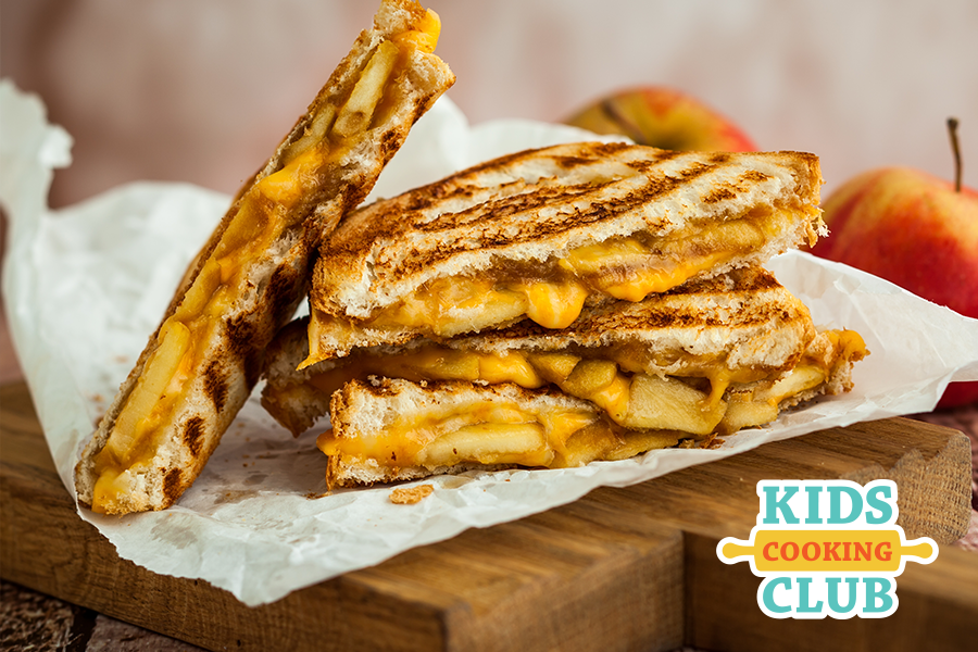 Grilled cheese sandwich with sliced apples on a plate