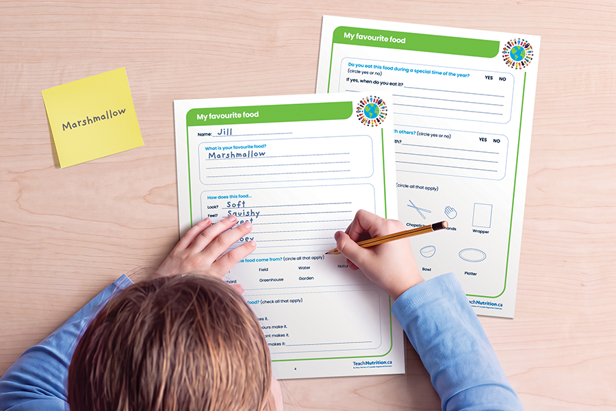 A child filling out worksheets on a desk.
