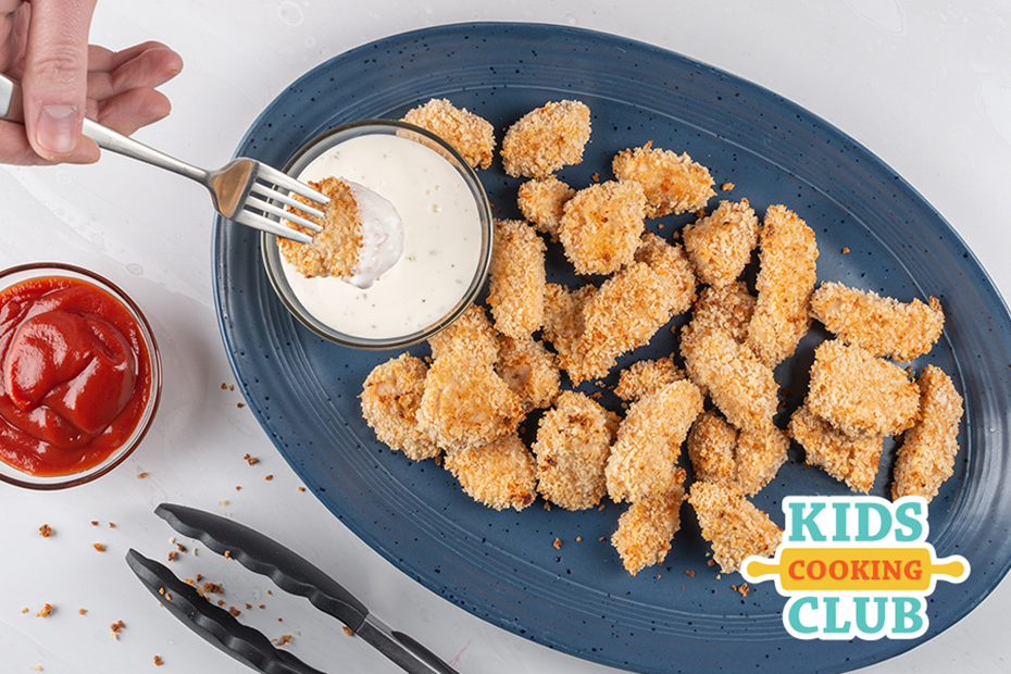 popcorn chicken in a plate with a cheese sauce