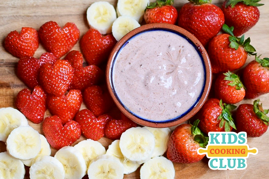 strawberry chocolate yogurt dip in a bowl served with sliced fresh strawberries and bananas 